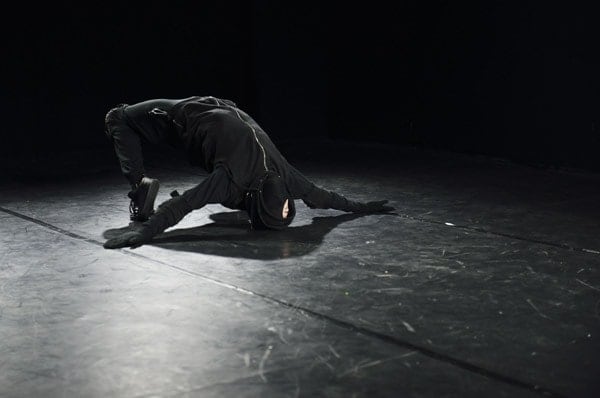 Black and white photograph of a performer in motion