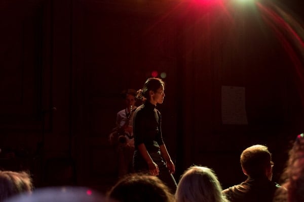 photo of a performer standing on the stage